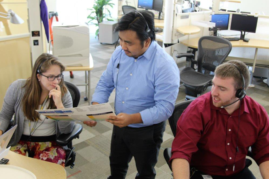 From left to right, Meg Tomasik, James Yang and Greg Ross discuss a project at our Appleton Call Center.