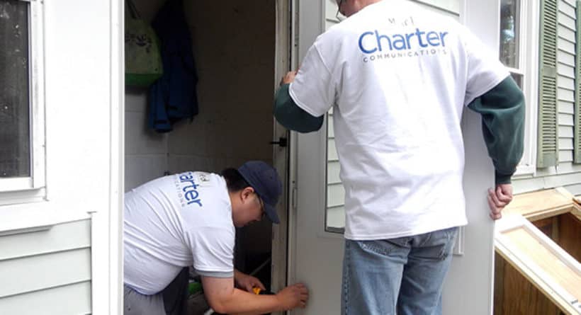 Charter our Community volunteers Ted and Mark install a new storm door at a Charter our Community-Rebuilding Together event in New Milford, Connecticut
