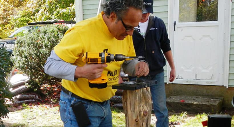 Charter House Captain Bill installs a base for a new mailbox at a Charter our Community-Rebuilding Together event in New Milford, Connecticut