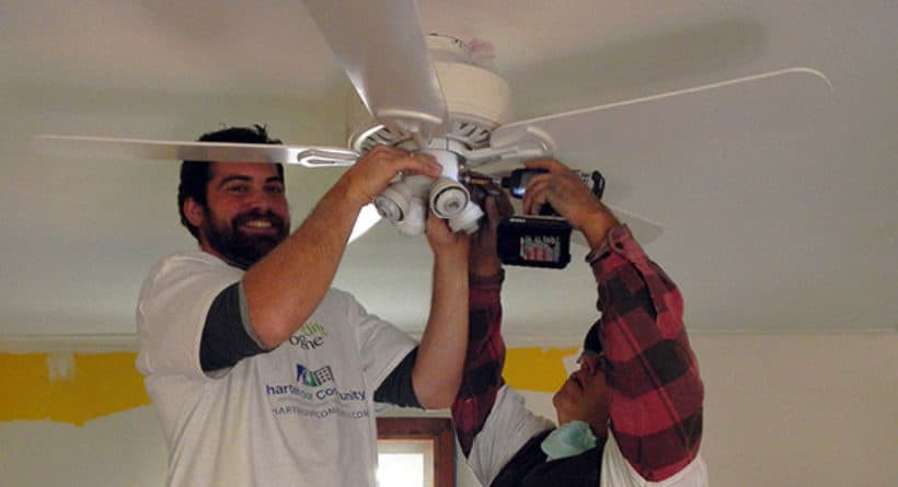 Charter volunteers Dan and Howard install a ceiling fan at a Charter our Community-Rebuilding Together event in New Milford, Connecticut