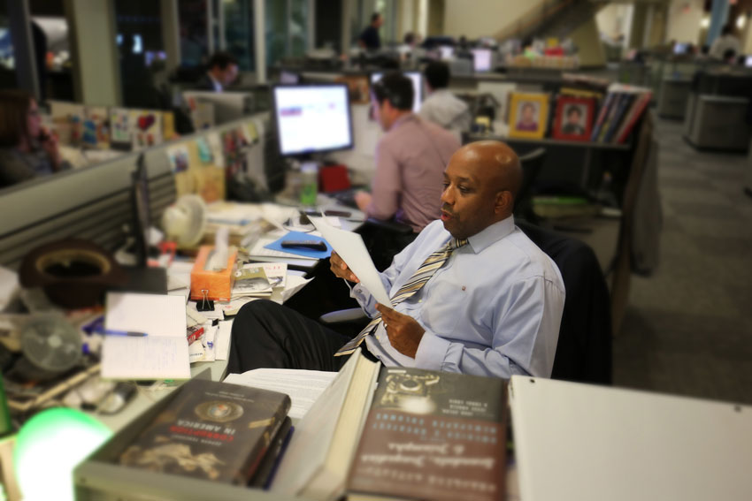 Errol Louis, Political Anchor and Host of NY1’s Inside City Hall, prepares at his desk in the newsroom to moderate Sunday's debate.