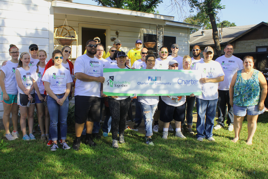 An image of Charter and Rebuilding Together volunteers in front of the Fort Worth, Texas rebuild. 