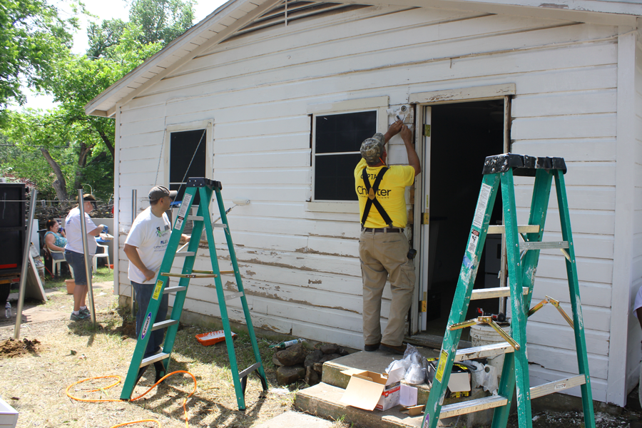 An image of Charter our Community volunteers rebuilding the exterior of a Fort Worth, Texas home. 