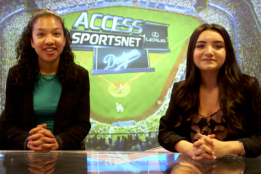 Two students check out the “Access SportsNet: Dodgers” anchor desk.