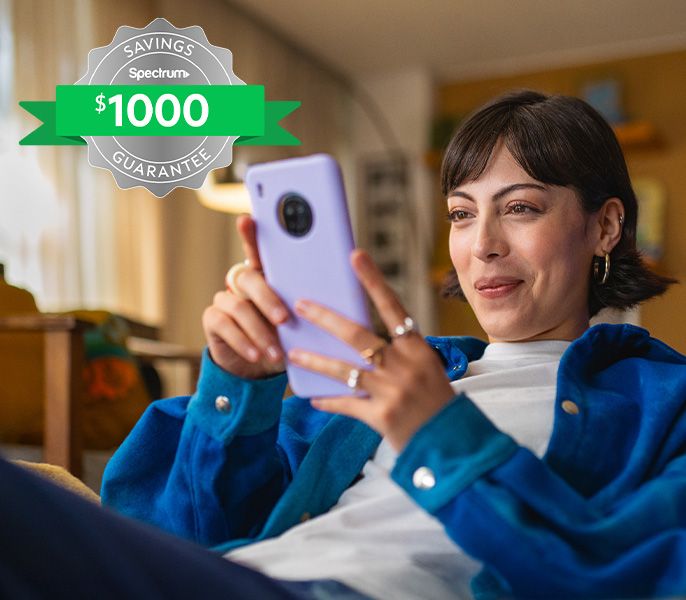 A woman using her cell phone looking happy