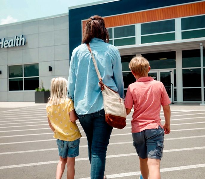 A family walking across a parking lot toward the DaySpring Health Center