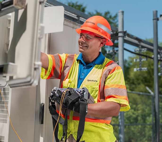 A Spectrum field technician working on the network