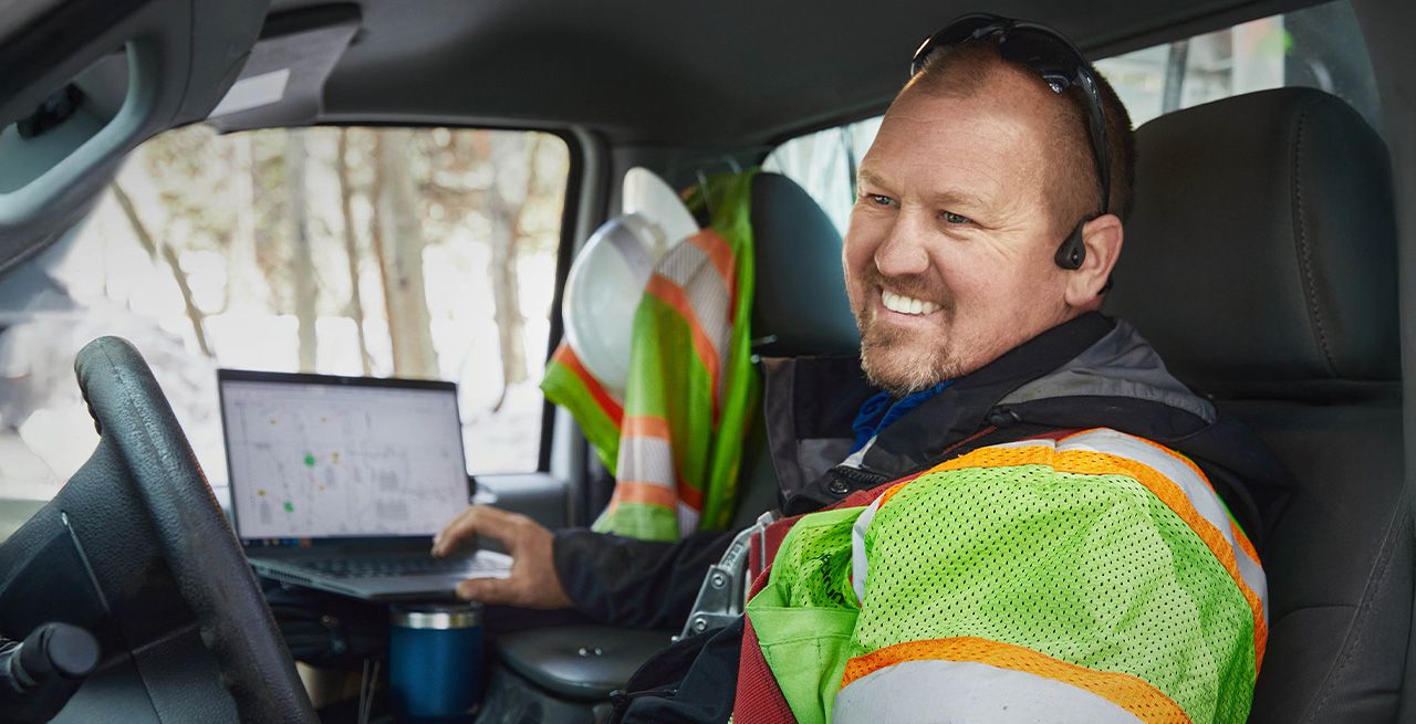 Spectrum technician in his work van, smiling 