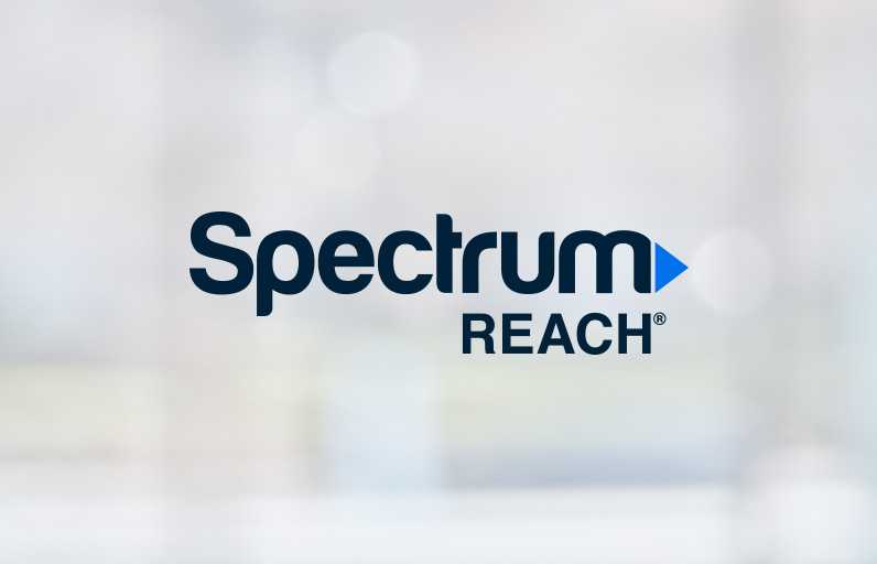 Image of Spectrum Reach logo on blurred background.