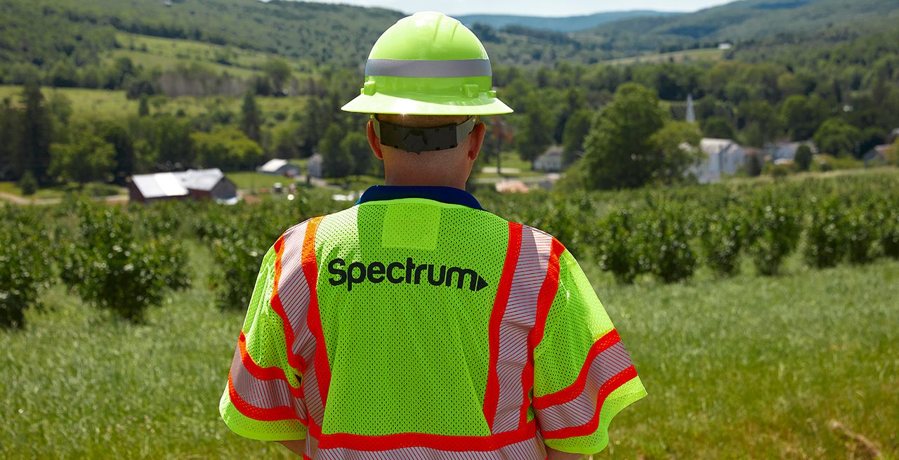 Spectrum technician surveying a rural area for a broadband expansion project