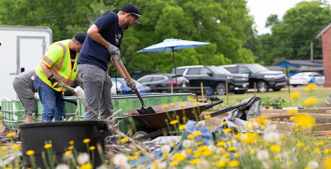 Spectrum volunteers working on a garden at a community center during a volunteer event