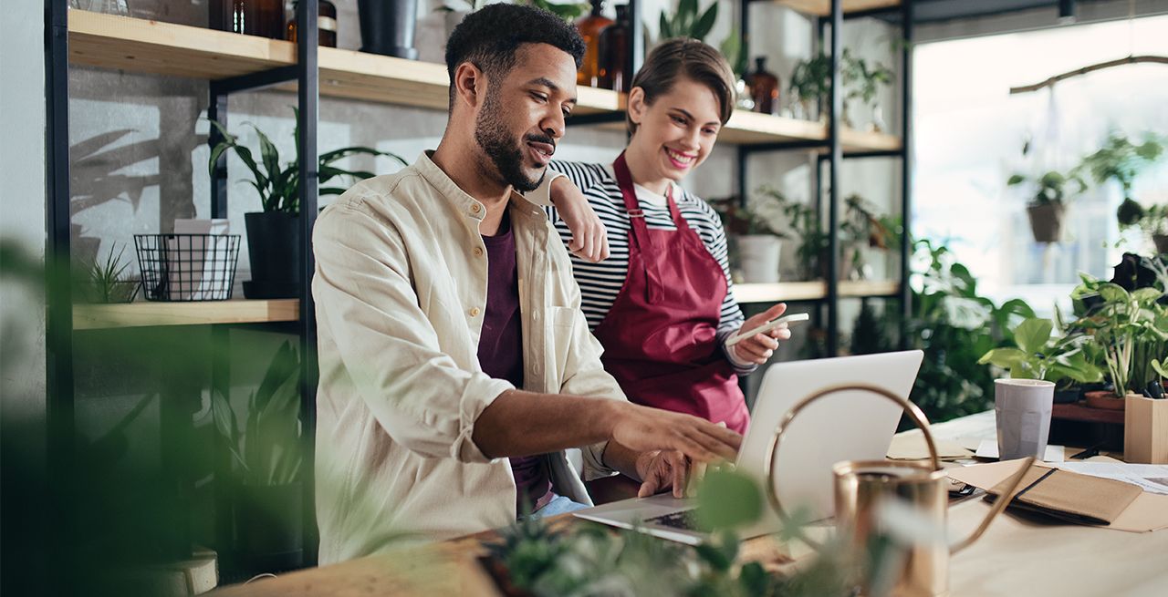 Man and woman working on a laptop in their small business