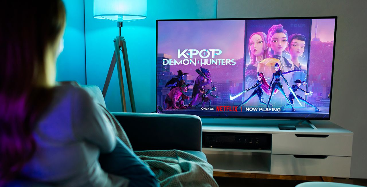 Person watching Netflix with KPop Demon Hunters on screen