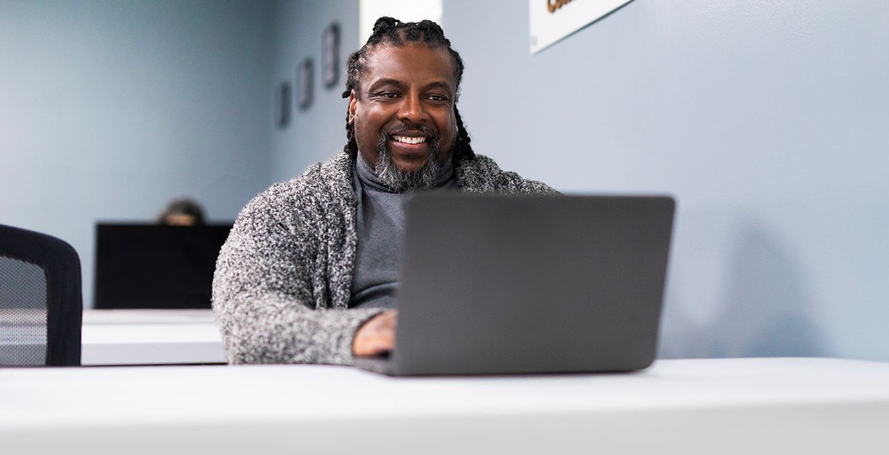 An adult student using a laptop in a computer lab 