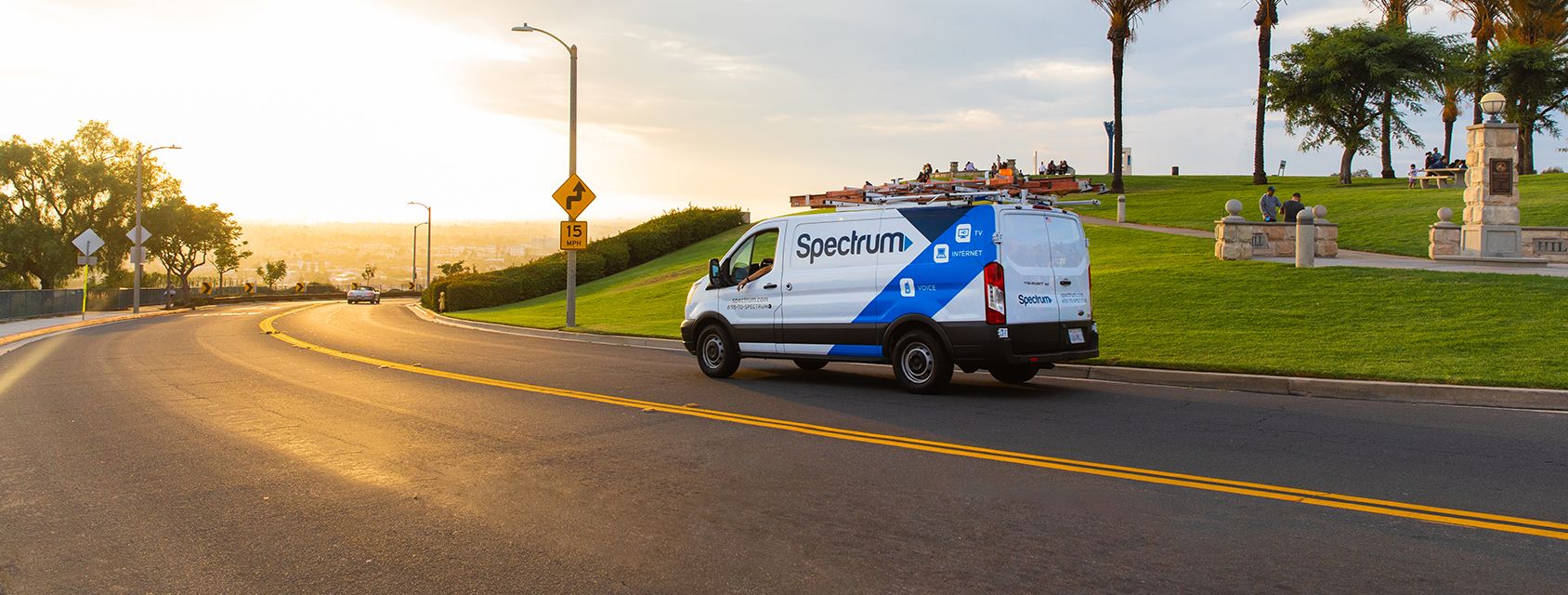 Spectrum van riding into the sunset on an open road
