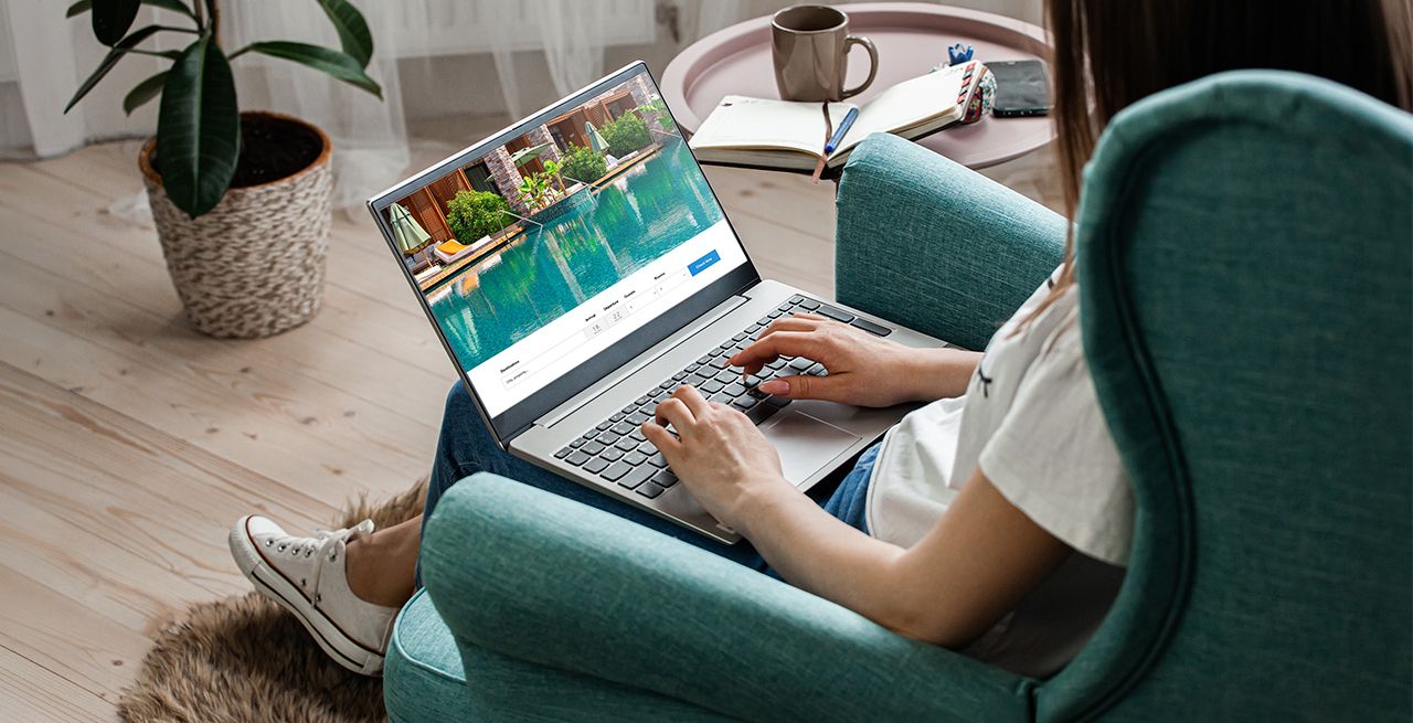 Someone using their laptop to search travel related content