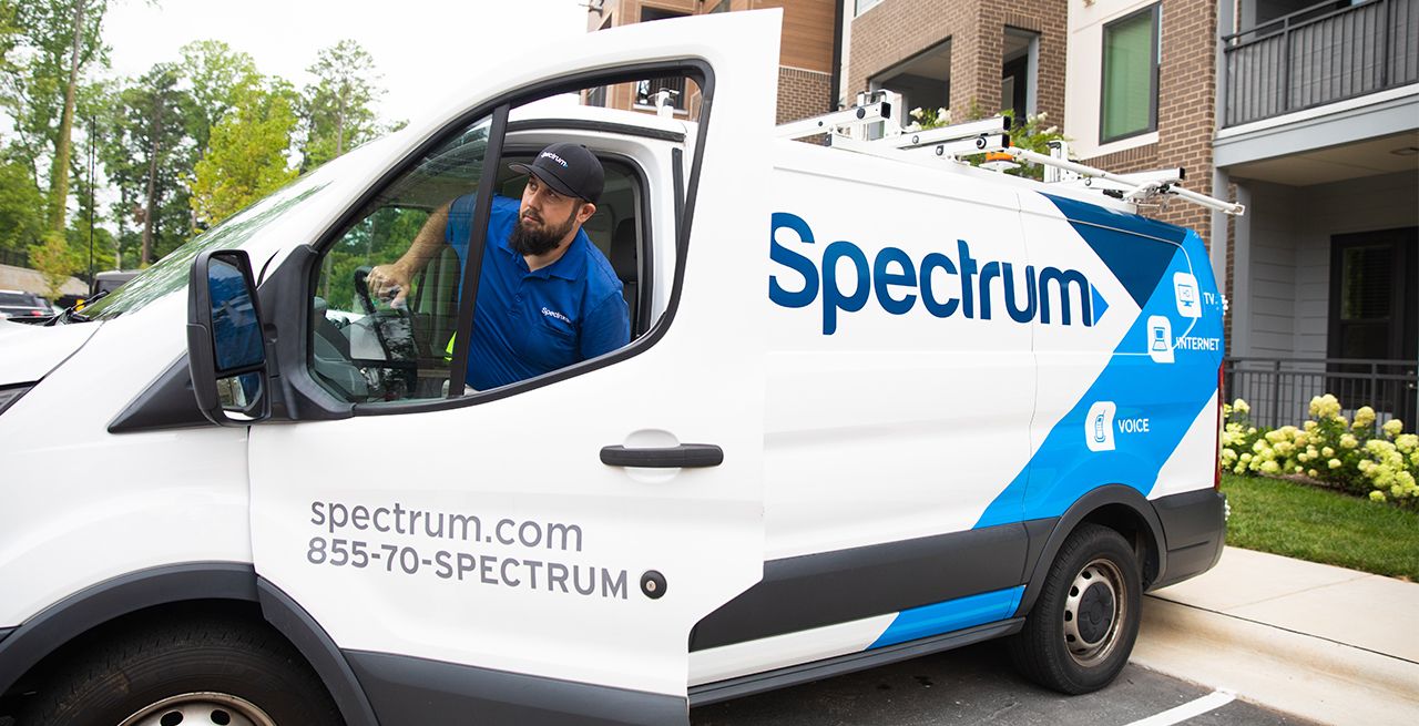 Spectrum technician arriving at a customers residence in a Spectrum van