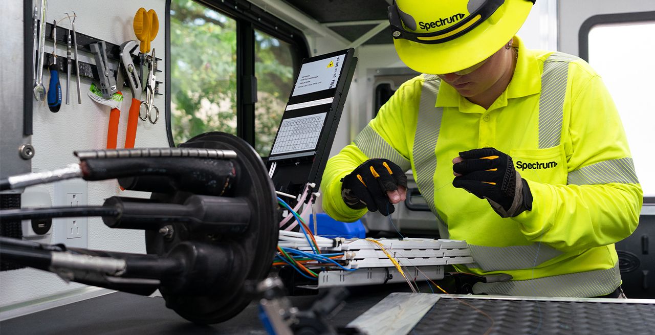 A Spectrum fiber technician splicing fiber