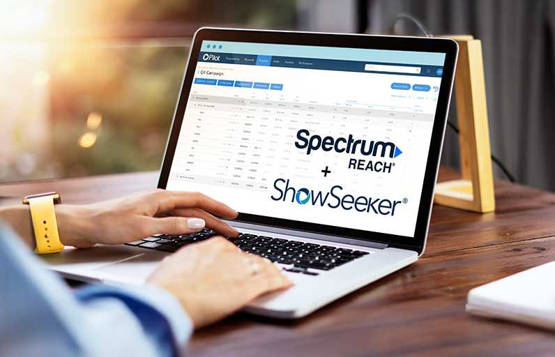 Image of a laptop with Spectrum Reach and ShowSeeker logos
