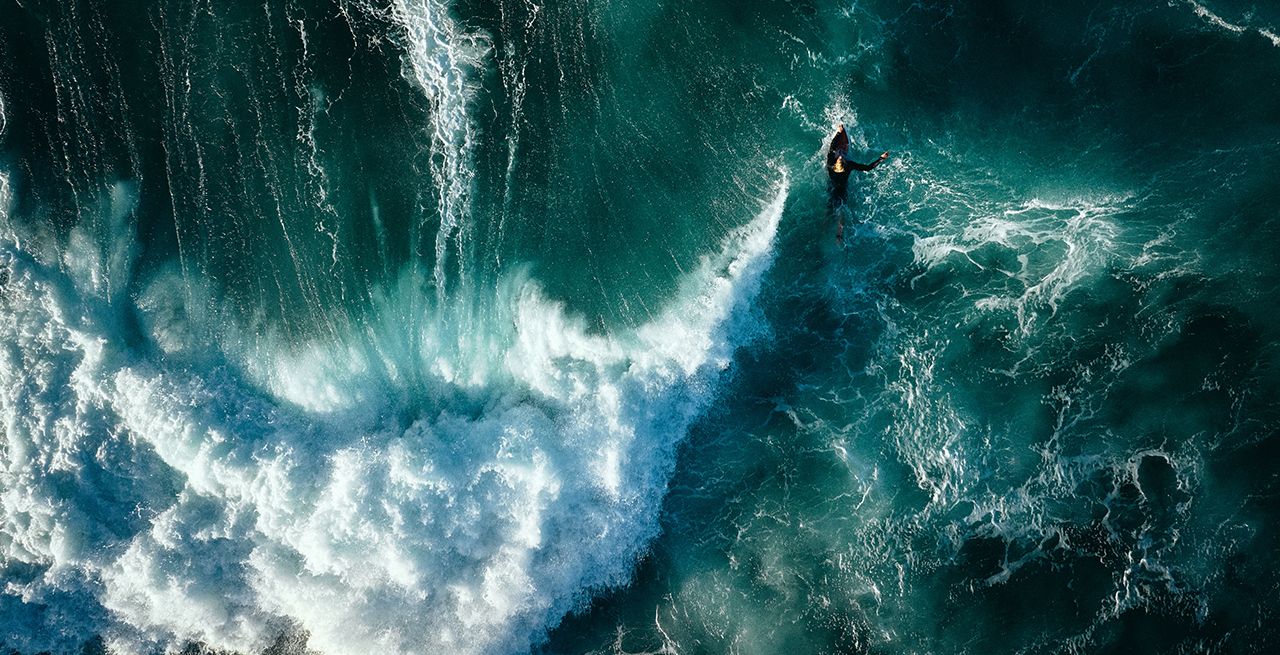 One of Orion Owens' aerial drone photographs of a surfer riding a wave