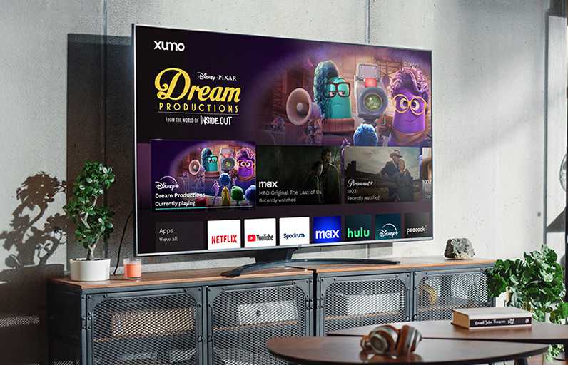 Someone watching TV in their living room with Xumo stream box user interface on the screen