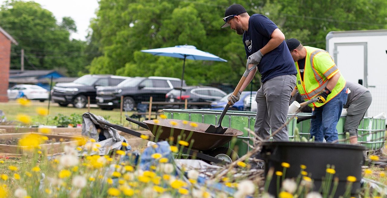 Spectrum volunteers working on a garden at a community center during a volunteer event