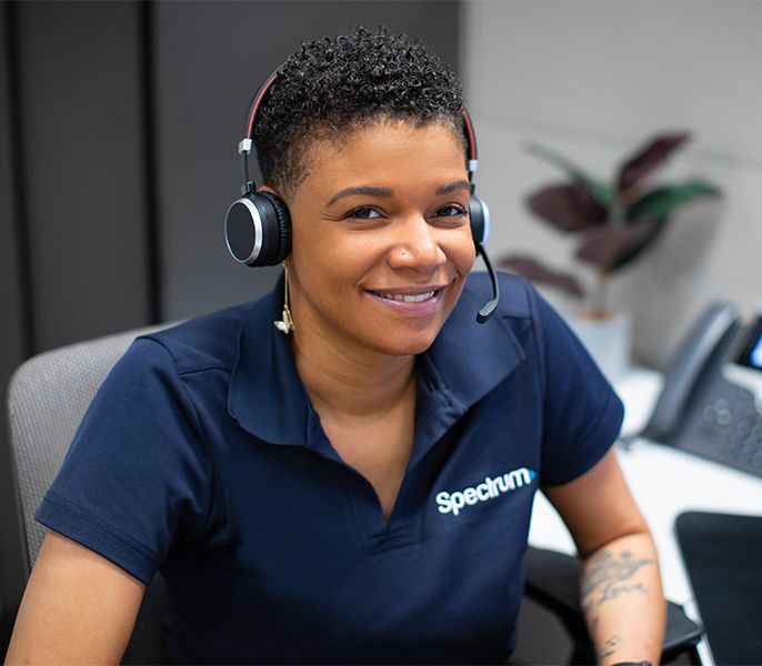 A Spectrum call center agent assisting customers, with headset on