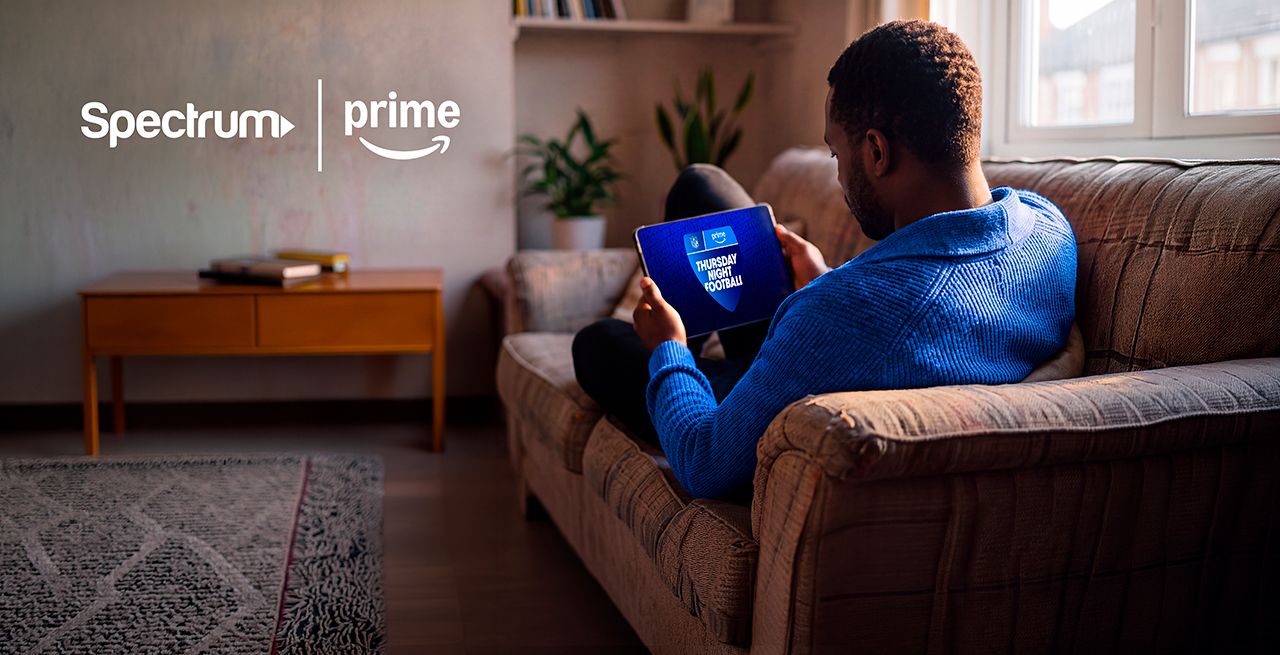 Man on couch watching Amazon Prime
