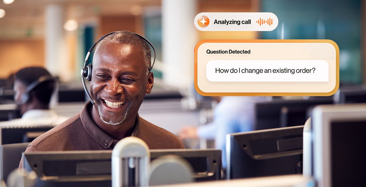 A call center agent with headset on, smiling