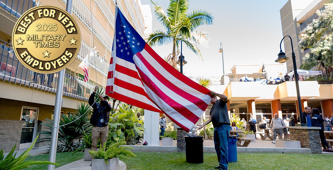 Veterans holding an American flag at a ceremony