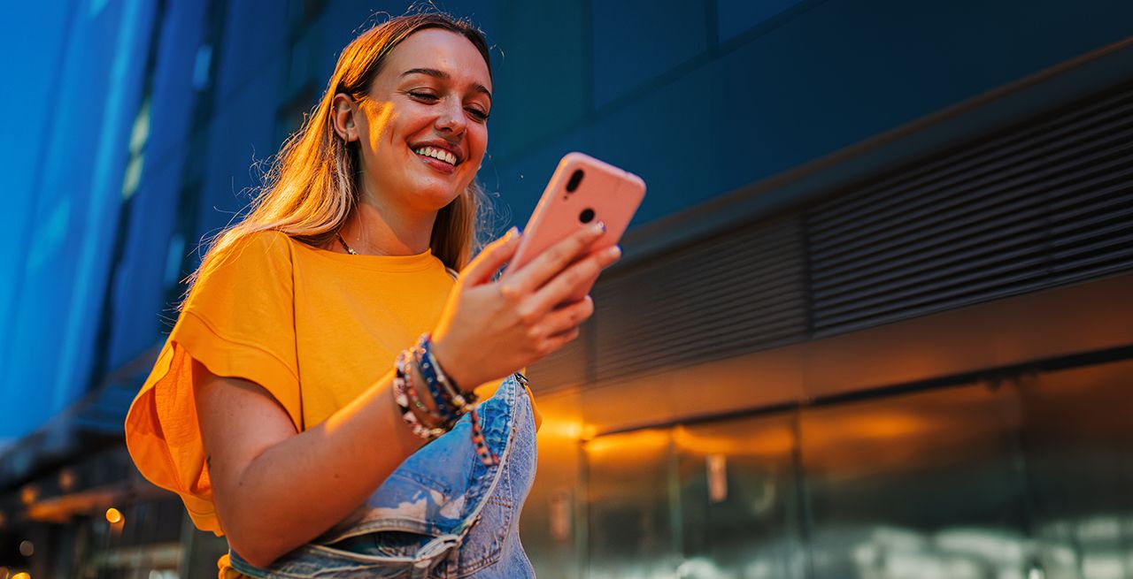 Woman using her smartphone and smiling