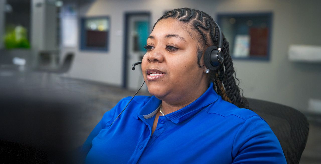 A Spectrum customer service rep smiling in a call center