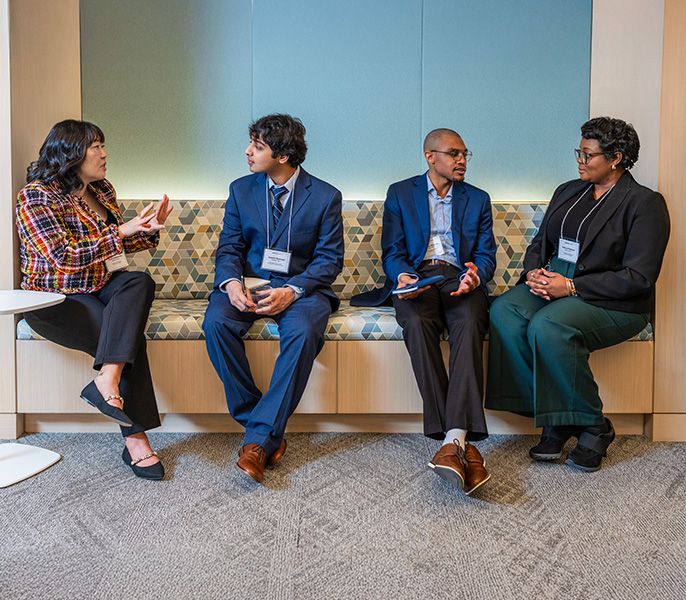Spectrum Scholars sit and talk during an event