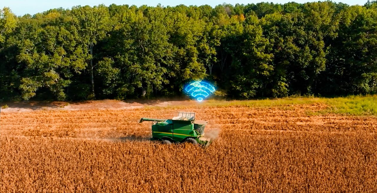 A harvester in a field with WiFi icon