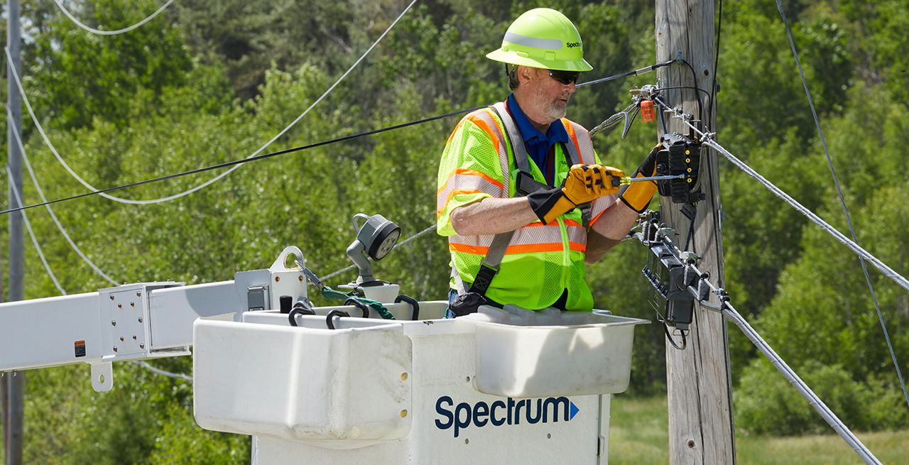 Spectrum technician working on broadband expansion project