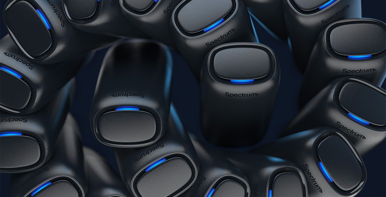 Multiple Spectrum WiFi 7 routers arranged in a swirl pattern viewed from the top