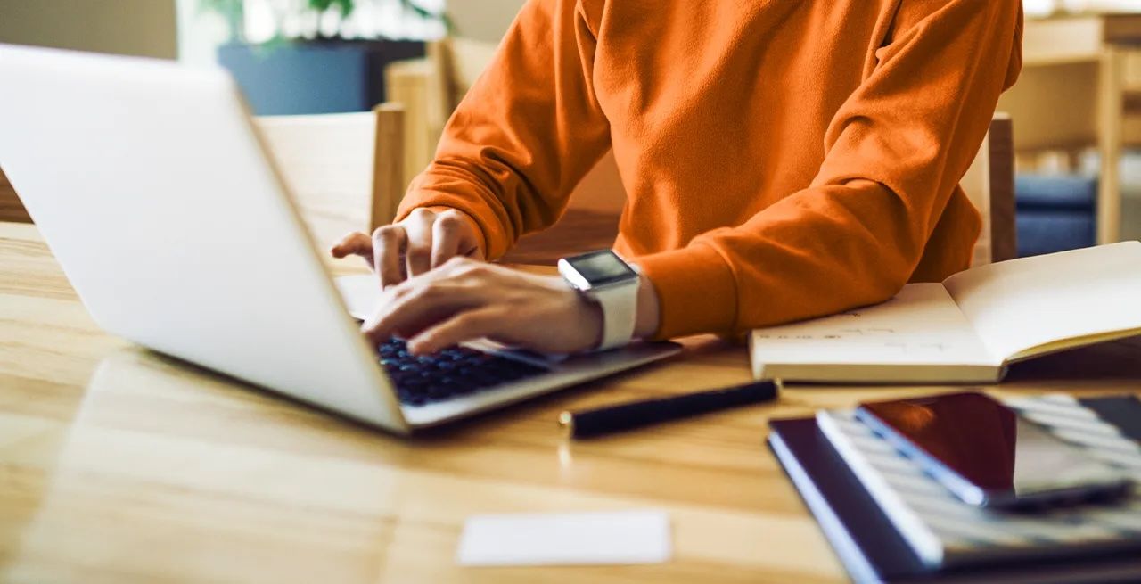 Journalist working on a laptop hand showing only